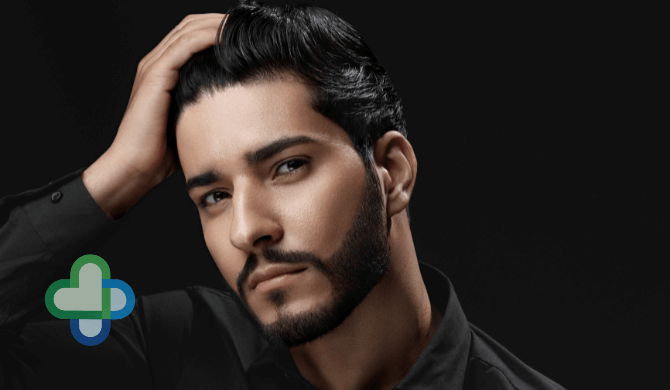 man with hair loss looking in mirror - buy cheap hair loss treatment online - the family chemist