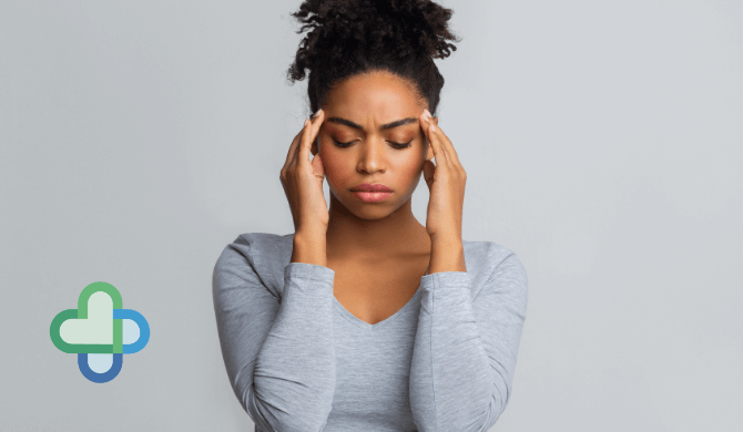 woman with a headache holding her head - buy cheap headache treatment online - the family chemist