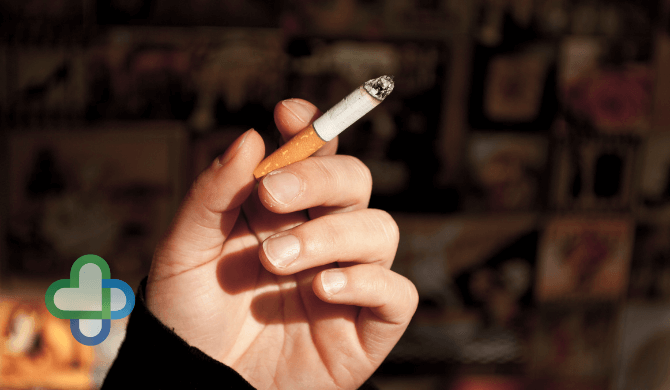 person holding a cigarette - buy stop smoking treatment