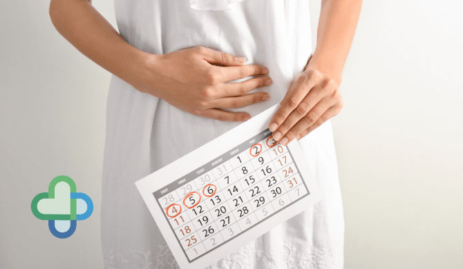 woman holding stomach during period delay treatment - buy period delay treatments