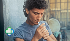man smoking cigarette - quit smoking the family chemist